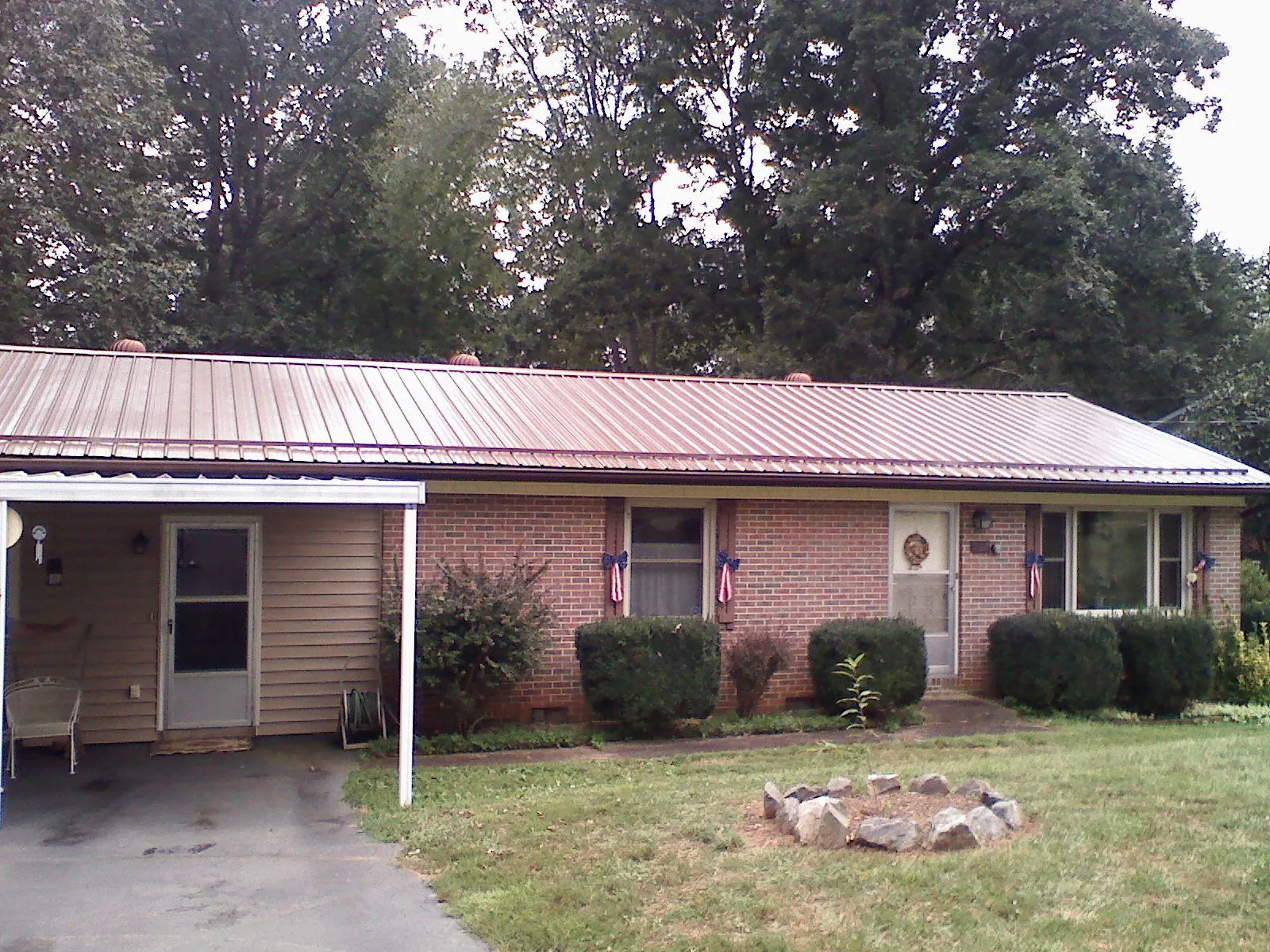Bronze metal roof and carport on a brick ranch home — Roof Repair work by our crew in South Thomaston